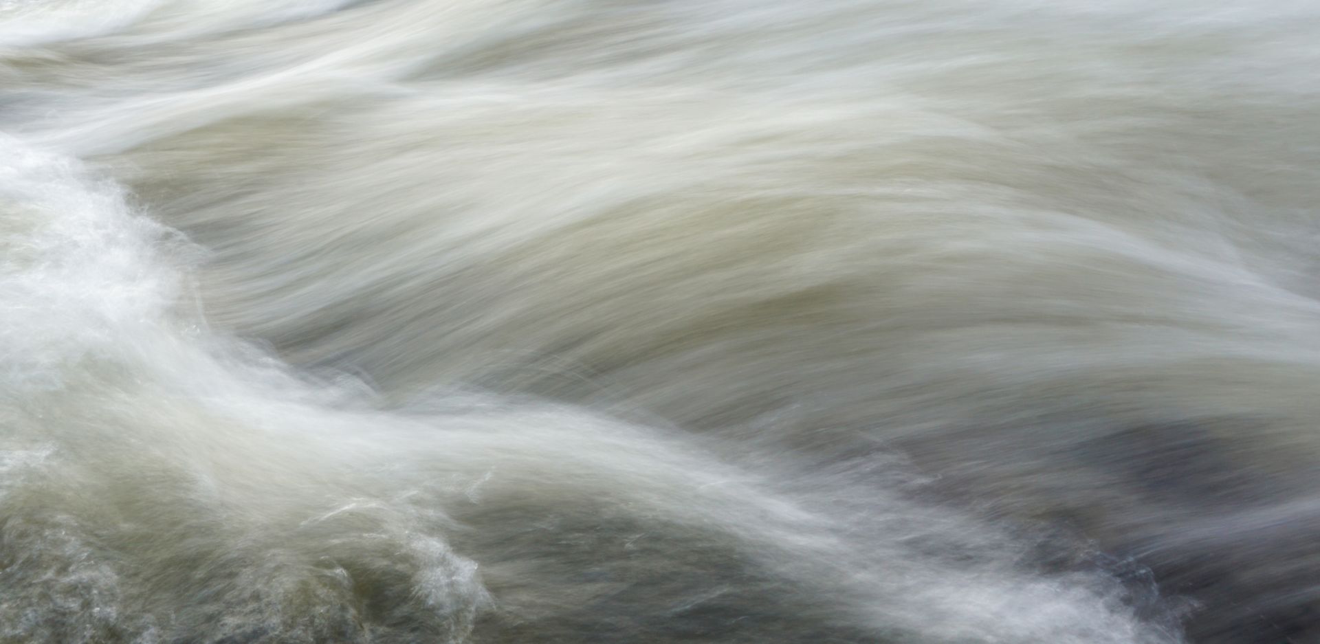 Capture the serene yet powerful motion of flowing water with this stunning close-up